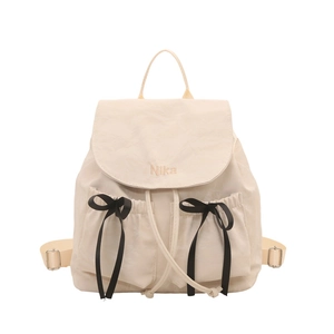 Sac à dos femme en nylon crème avec nœuds noirs et broderie Nika élégante