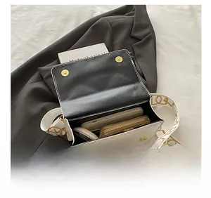 Internal view of a white leather crossbody bag showing its large storage capacity