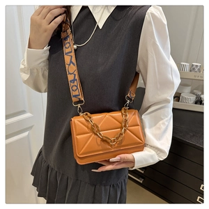 Chic orange crossbody bag with geometric quilting and stylish wide printed strap