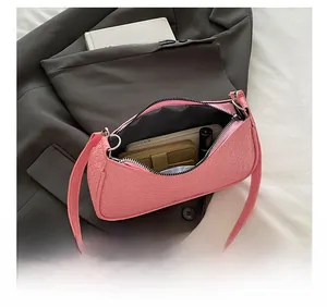 Top view of pink crossbody bag interior showing storage for phone and lipstick