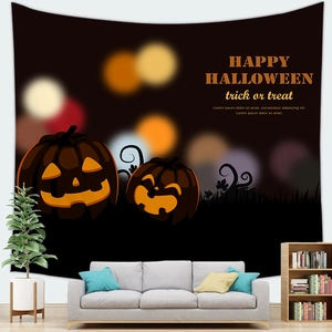 Halloween pumpkin tapestry displayed over a gray sofa in a cozy home living room