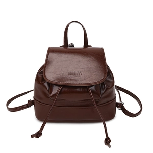 Minimalist dark brown drawstring backpack with glossy synthetic leather and flap closure