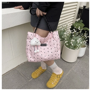 Pink quilted tote with bow print, woven handles and cute plush cloud charm