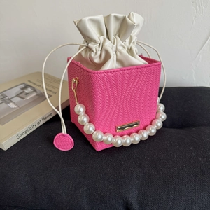 Chic magenta cube drawstring bag with pearl handle and woven texture detail