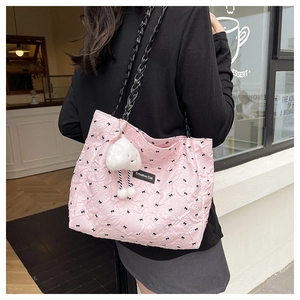 Pink quilted tote bag with black bow print and cute white cloud plush pendant