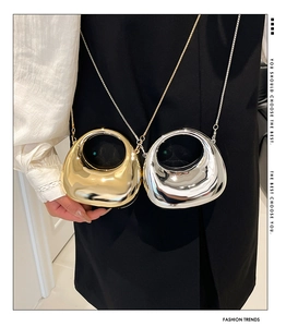 Close-up of gold and silver metallic mini chain bags with polished mirror finish