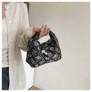 Detail of ethnic tote bag with geometric embroidery, drawstring and white pearl beads