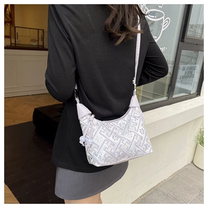 Close-up of lilac hobo bag with silver geometric patterns and lavender leather accents