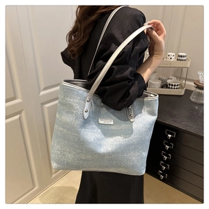 Sac fourre-tout bleu clair scintillant porté par un mannequin pour le style