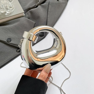 Chic silver mirror crescent handbag with a unique hollow circular design and chain strap