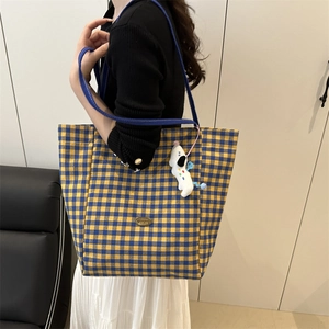 Yellow and blue gingham canvas tote bag with a white plush puppy charm decoration