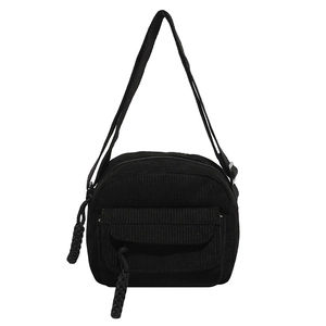 Fashionable black corduroy crossbody bag with front flap pocket and woven rope zipper detail