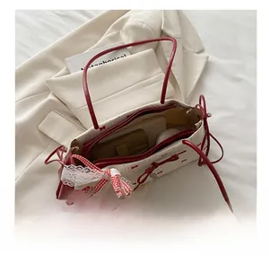Internal view of the bow-print tote bag showing capacity for cosmetics and accessories