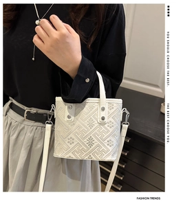 Detail of floral jacquard handbag with detachable shoulder strap and silver hardware