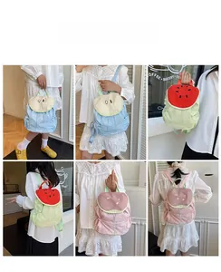 Detail view of cute fruit-themed canvas backpacks with drawstring closure in multiple colors