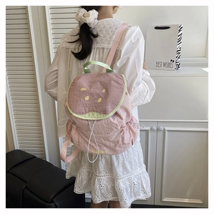 Sweet pink guava backpack with fruit-slice design shown in a soft lifestyle setting