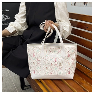 Detail of cute cartoon tote bag with pink patterns on textured jacquard fabric material
