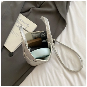 Macro detail of the silver pebble grain leather mini crossbody bag with interior storage space