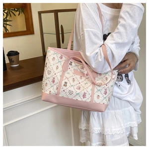 Detail of pink cartoon tote bag with cute bear patterns and dual strap handles