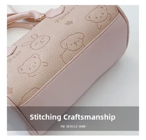 Detailed stitching and embossed cartoon pattern on pink textured leather handbag
