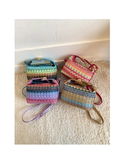 Detail of four colorful woven straw bucket bags with leather handles and straps