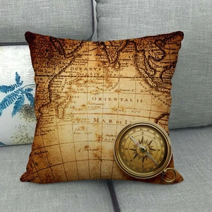 Vintage nautical map square throw pillow with compass design on a grey sofa