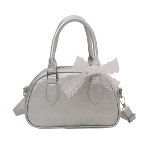 Silver glossy bowling bag with embossed patterns and white lace bow decoration