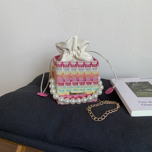Colorful woven mini bag with large pearl handle and stylish gold chain shoulder strap