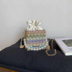 Woven pearl handle mini bucket bag with colorful wavy patterns and golden chain strap