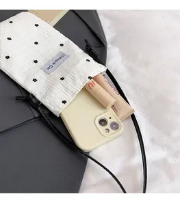 Detail of floral embroidery on white crinkle fabric crossbody bag with storage capacity