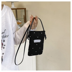 Close-up of black floral tote bag with wrinkled texture and Creative Cat label
