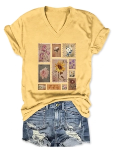 Detail of vintage flower stamp print on a yellow V-neck T-shirt with denim shorts