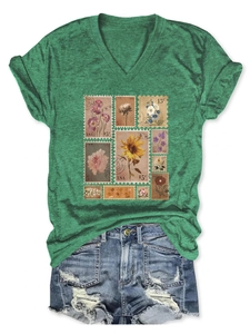Detail of vintage flower stamp print on dark green V-neck short sleeve T-shirt