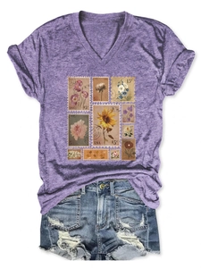 Flat lay of vintage purple V-neck T-shirt with flower stamp print and ripped denim shorts