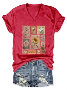 Flat lay of red V-neck T-shirt with vintage floral stamp print and denim shorts