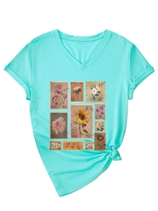 Detail of mint green V-neck T-shirt showing vintage floral stamp prints and side knot hem