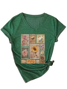 Detail of the V-neckline and vintage floral stamp print on this dark green t-shirt