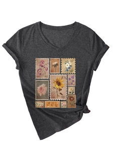 Detail of V-neck dark grey T-shirt with vintage floral stamp prints and knotted hem