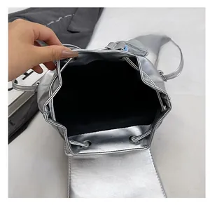 Top view of metallic silver bucket bag showing spacious interior and black lining