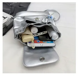 Top view of large capacity silver PU backpack showing interior storage for tech and essentials