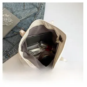 Top view of white hollow-out tote bag interior showing large capacity for daily essentials