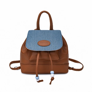 Women's vintage brown leather and denim backpack with drawstring closure and top handle