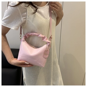 Detail of pink pleated PU shoulder bag with cloud handle and fashion tag charm