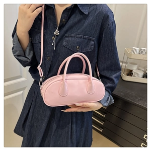 Detailed view of pink PU leather Boston bag with silver zipper and dual top handles