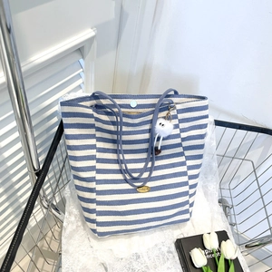 Blue and white striped canvas tote bag with magnetic closure and plush charm