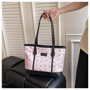 Detail of light pink tote bag featuring unique pleated texture and small black bows