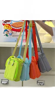Detailed view of four colorful mini nylon crossbody bags with front zip pockets and straps