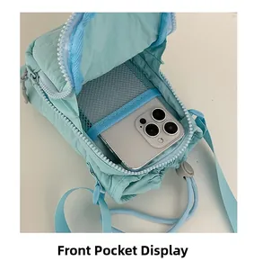 Front pocket display of light blue nylon phone bag showing internal mesh compartment