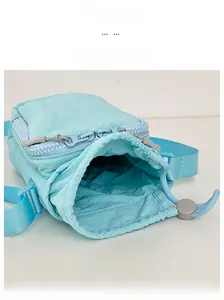 Internal view of light blue nylon crossbody bag showing spacious storage and drawstring