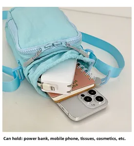 Detail of light blue nylon crossbody bag showing interior storage capacity for essentials